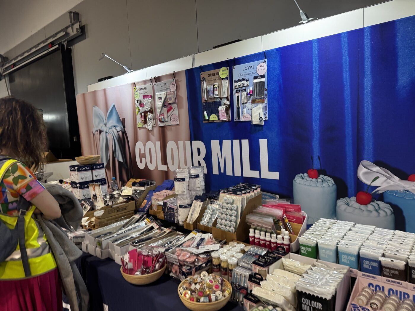 The Colour Mill stand with its product wall and shoppers browsing