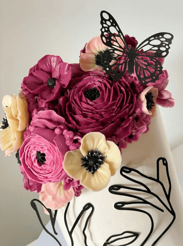 A buttercream cake decorated with piped and palette-knife flowers from the Buttercream Masterclass