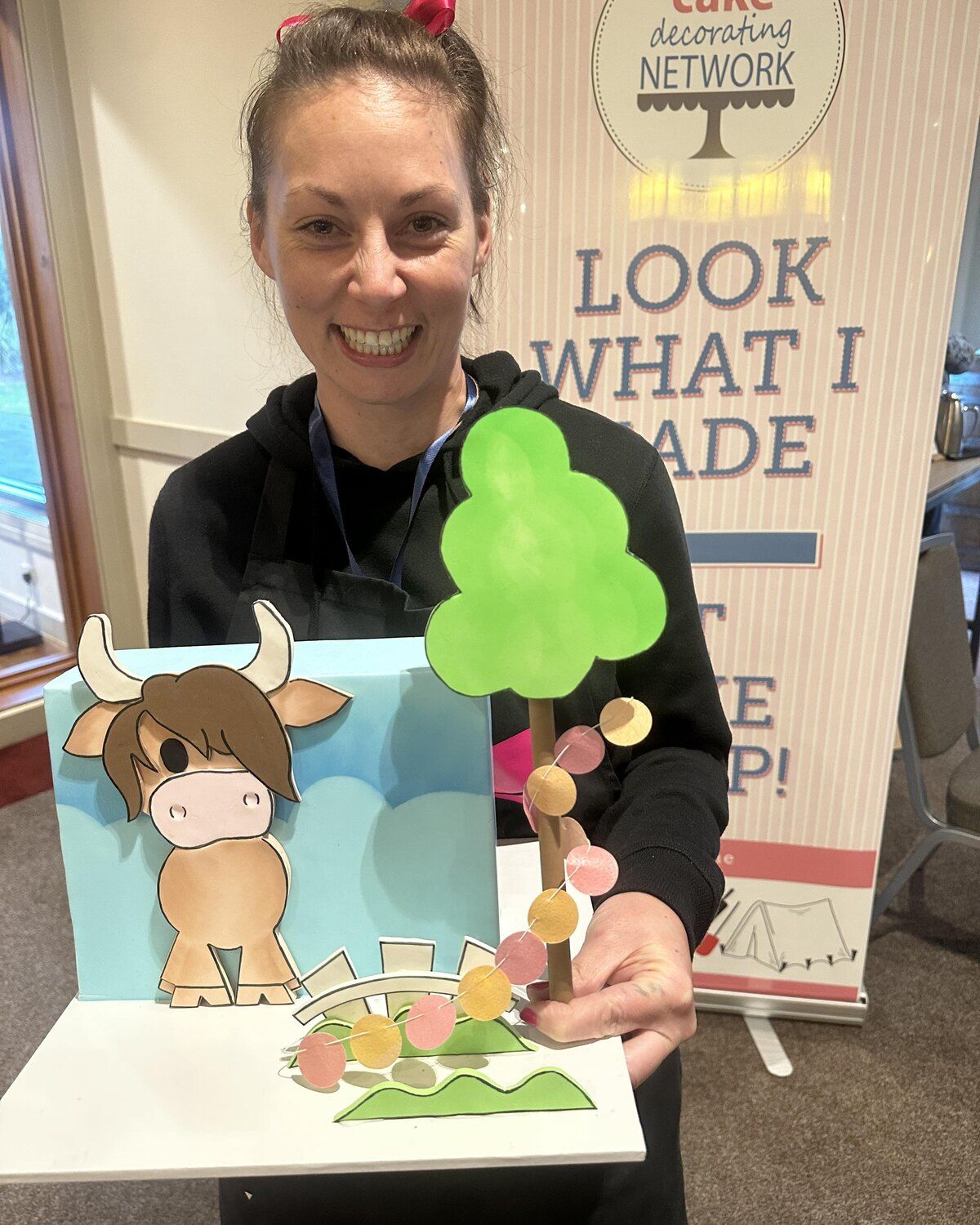 A member with her cake at Cake Camp