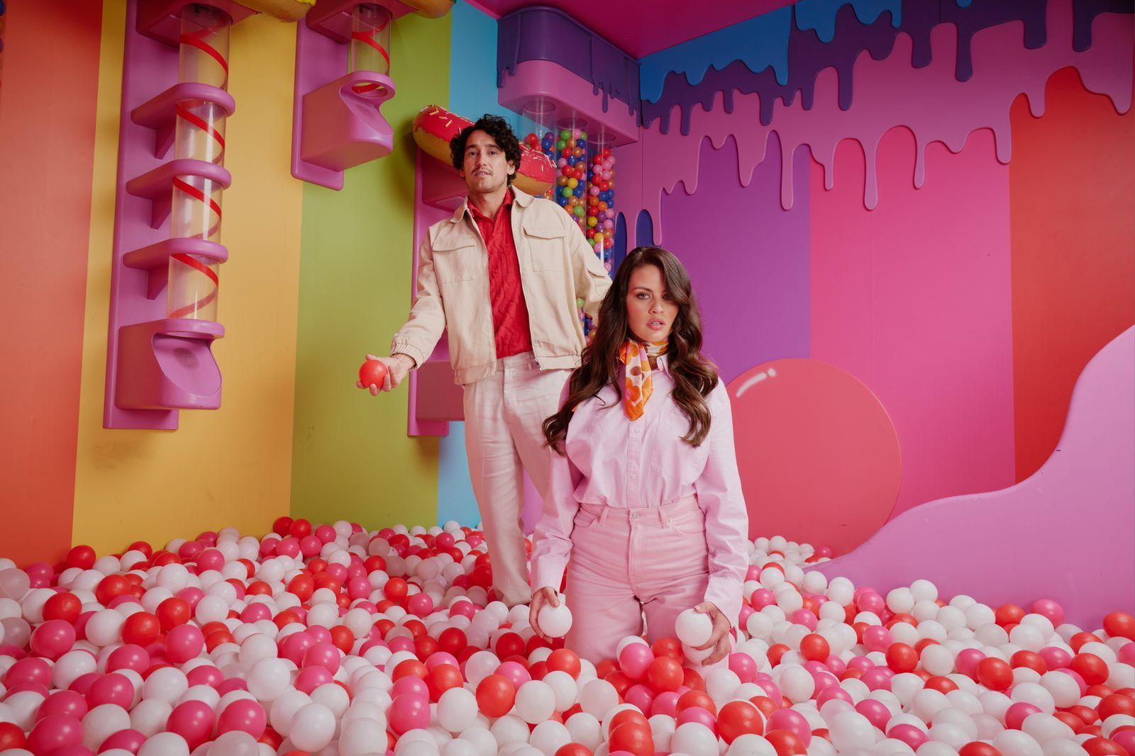 Two guests in a ball pit inside a Hijinx Hotel challenge room